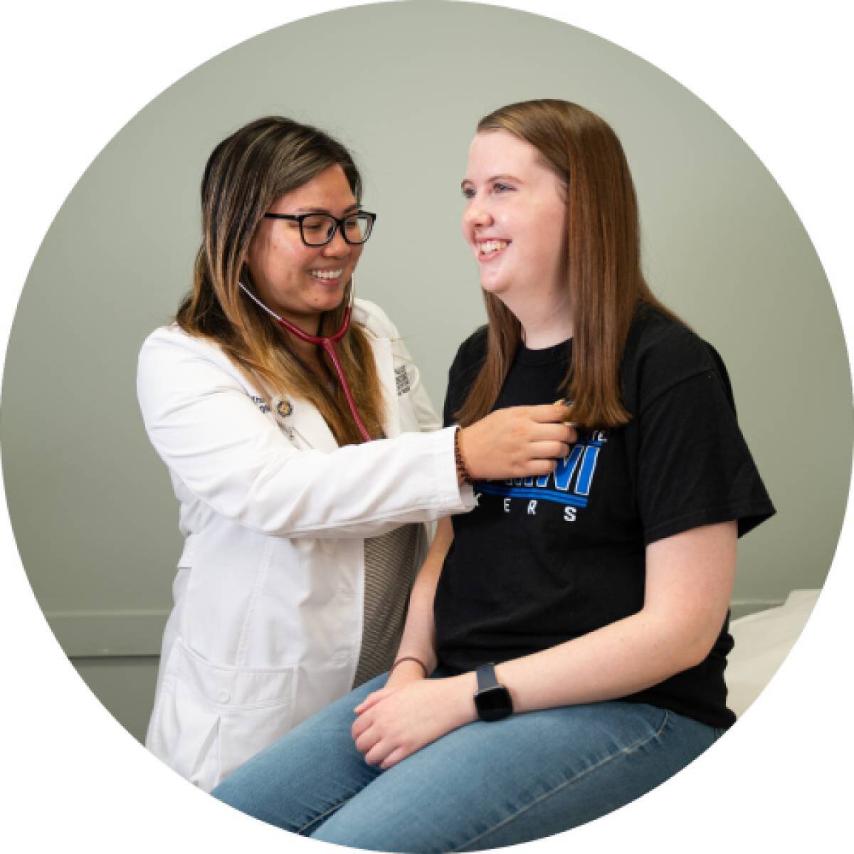 Graduate student in a clinical setting with a patient